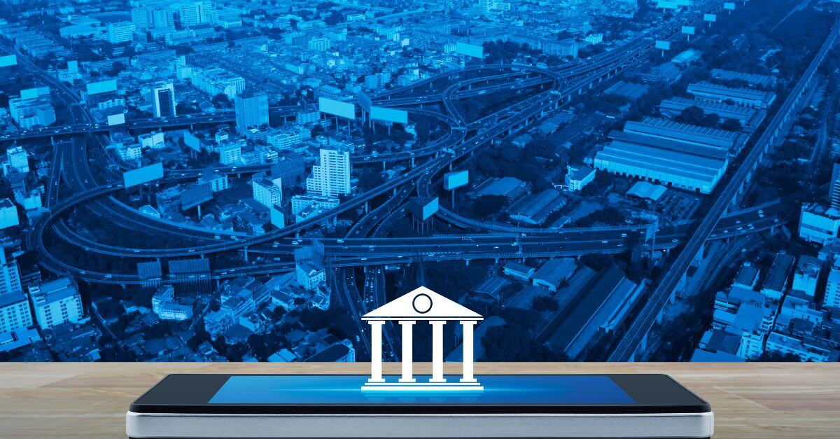 Bank icon appearing from an iphone with blue cityscape background 