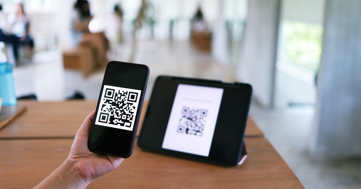 Person using QR code to scan through iphone